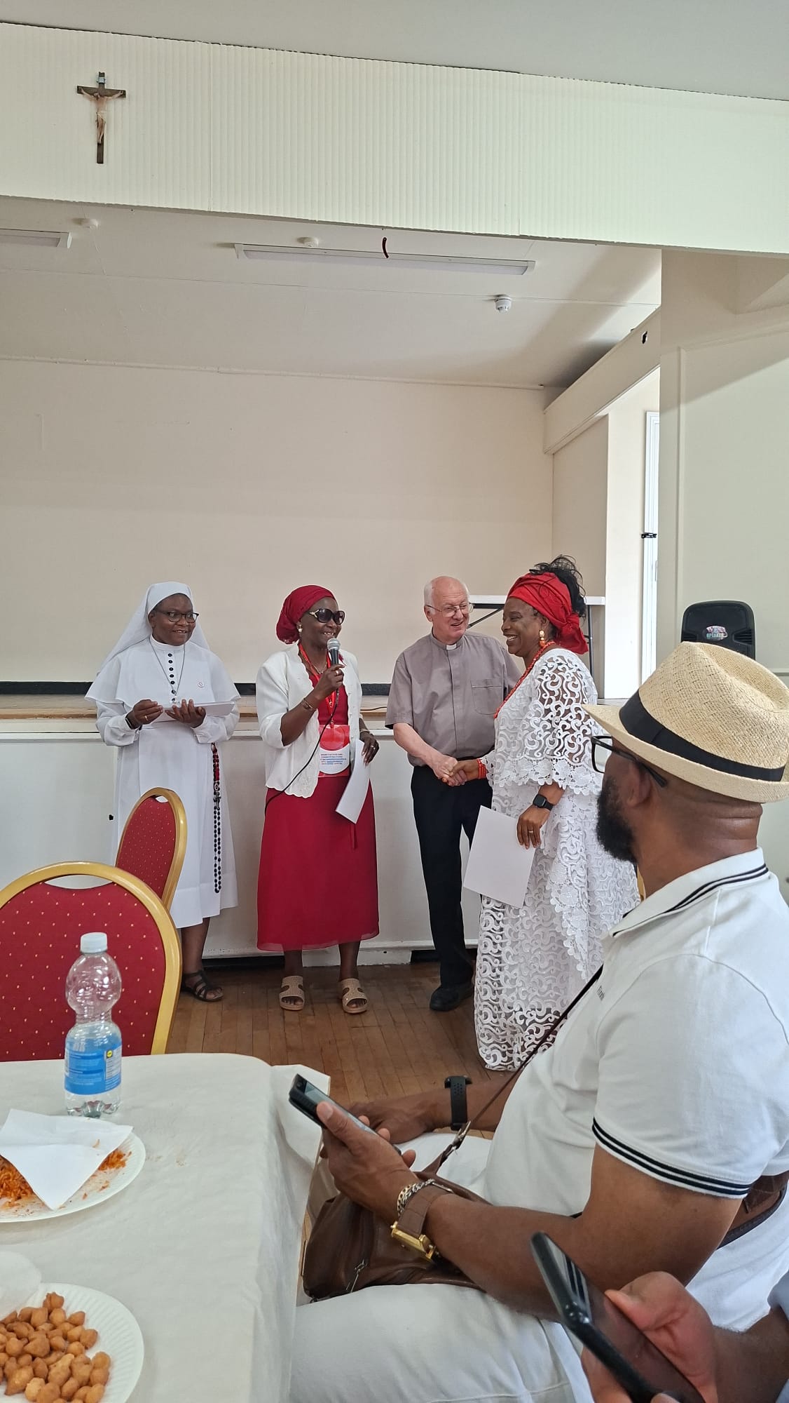 Devotee receiving a certificate during the Walthamstow consecration gathering