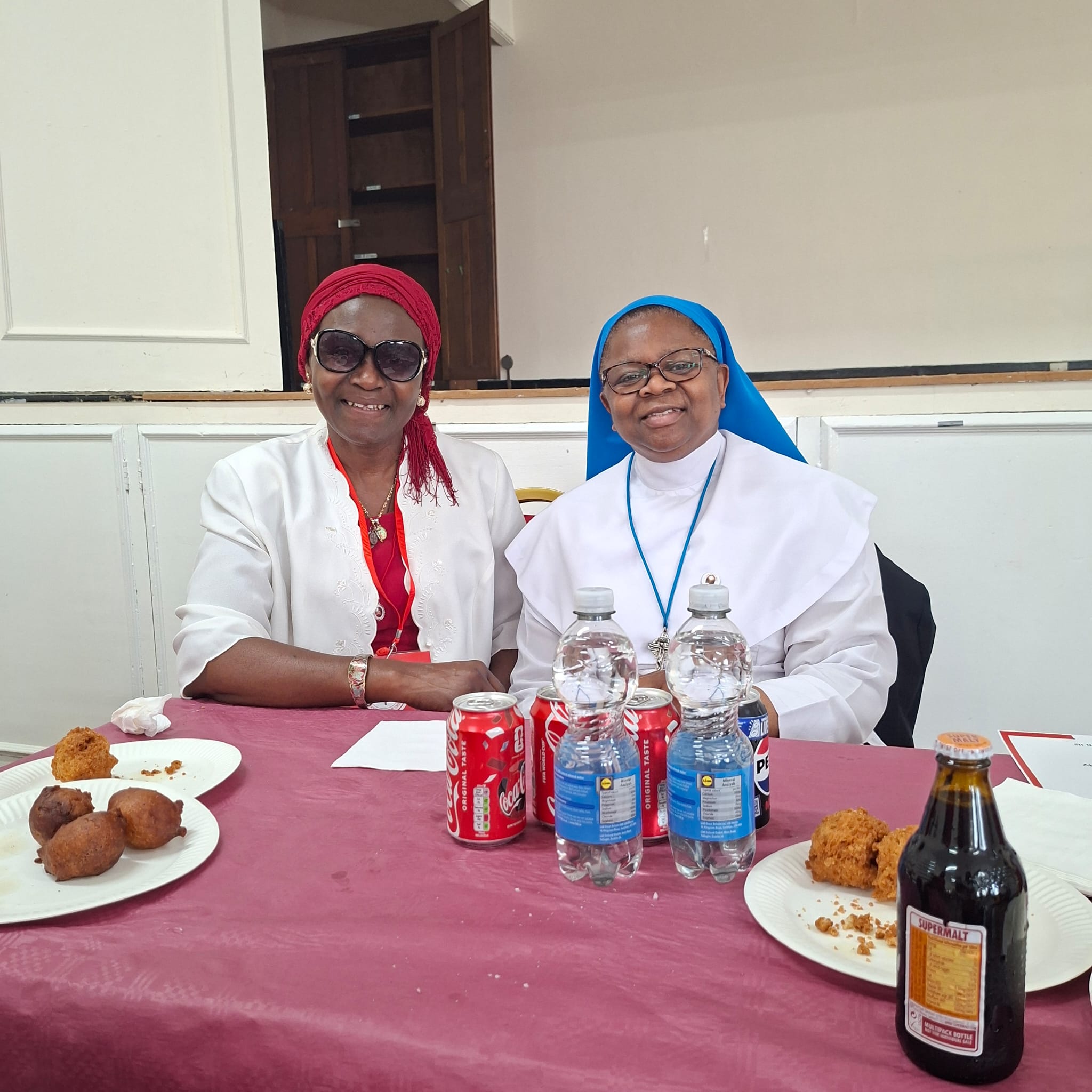 Sister and devotee seated after the consecration event
