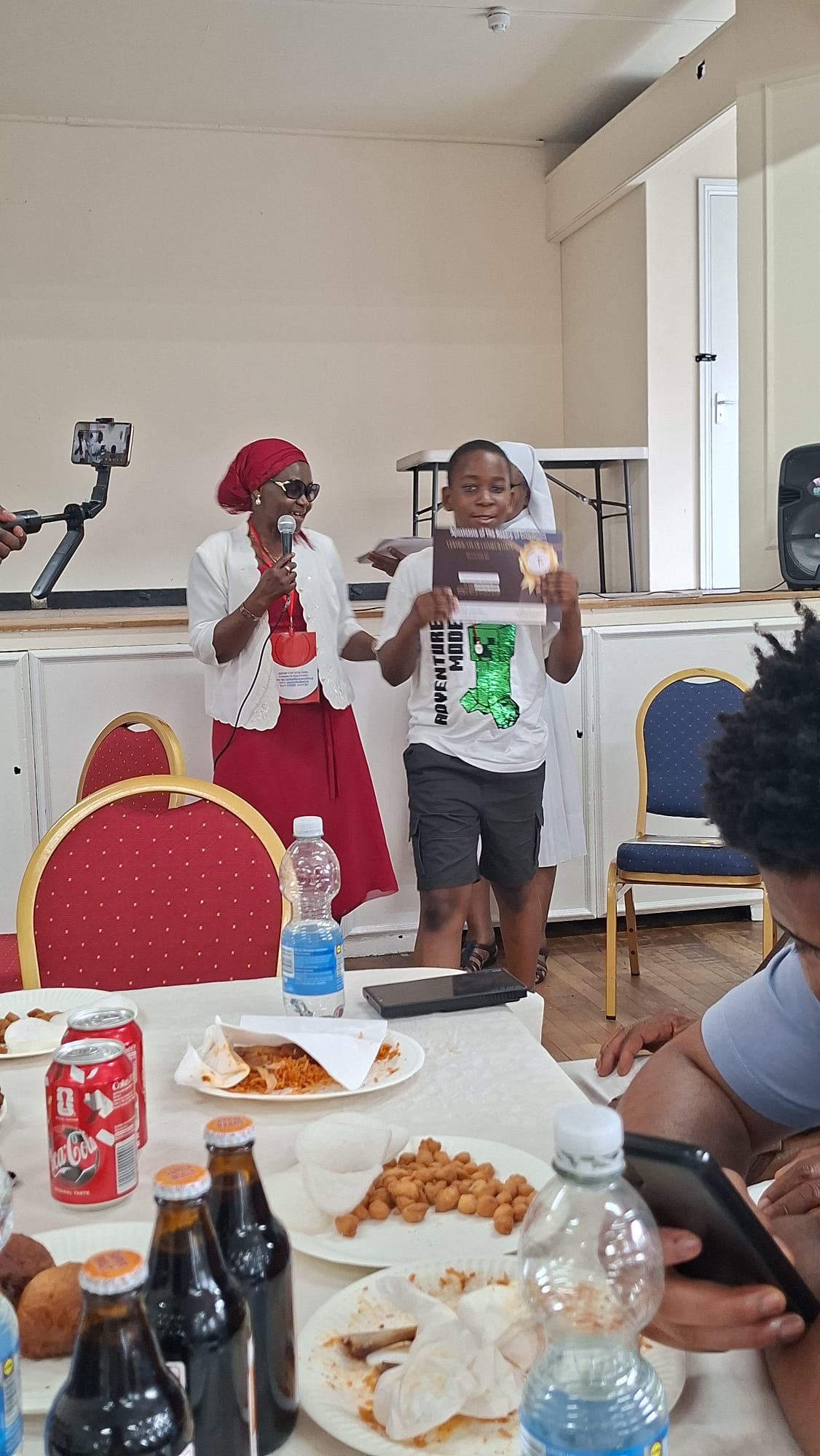 Young devotee holding a certificate at the Walthamstow event
